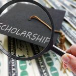 Graduation cap with the word "Scholarship" under magnifying glass over US dollar bills, symbolizing A 1 Auto Transport Scholarship opportunity
