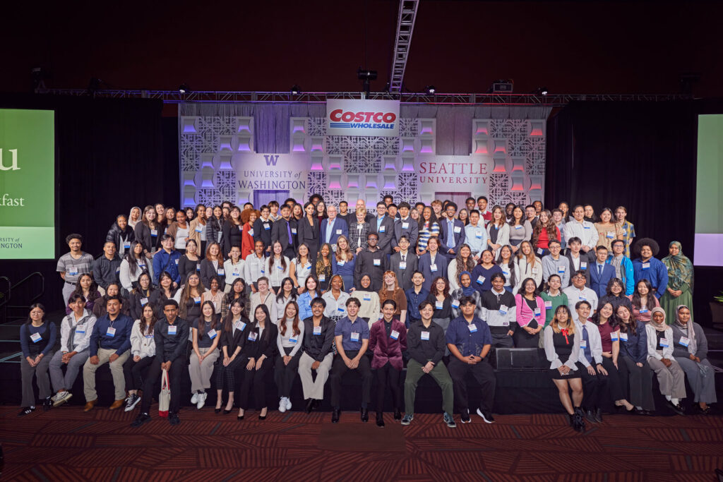 Group of diverse college students smiling, representing recipients of the Costco scholarship program for educational funding.