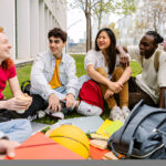Diverse group of college students celebrating educational success, benefiting from opportunities like the Golden Door Scholarship.